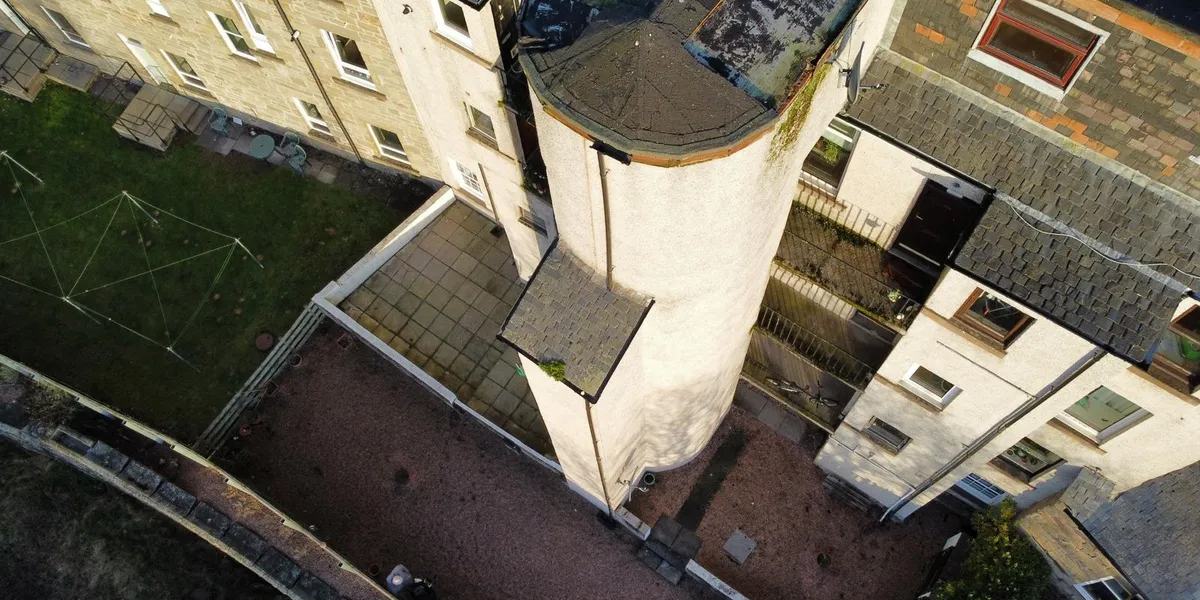 Aerial drone view of Dundee tenement rooftops during a roof survey