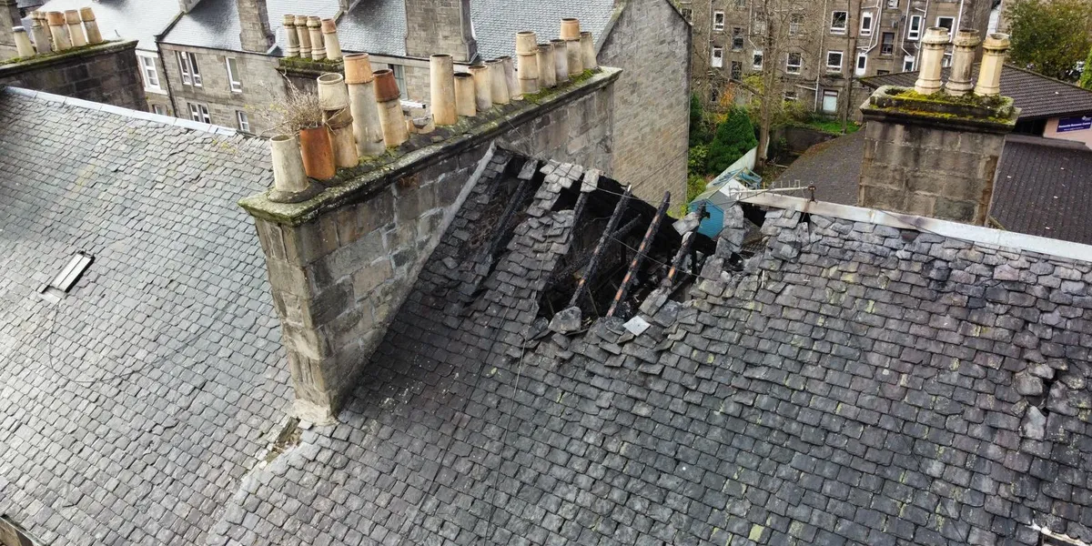 A collapsed section of a Dundee slate roof being repaired